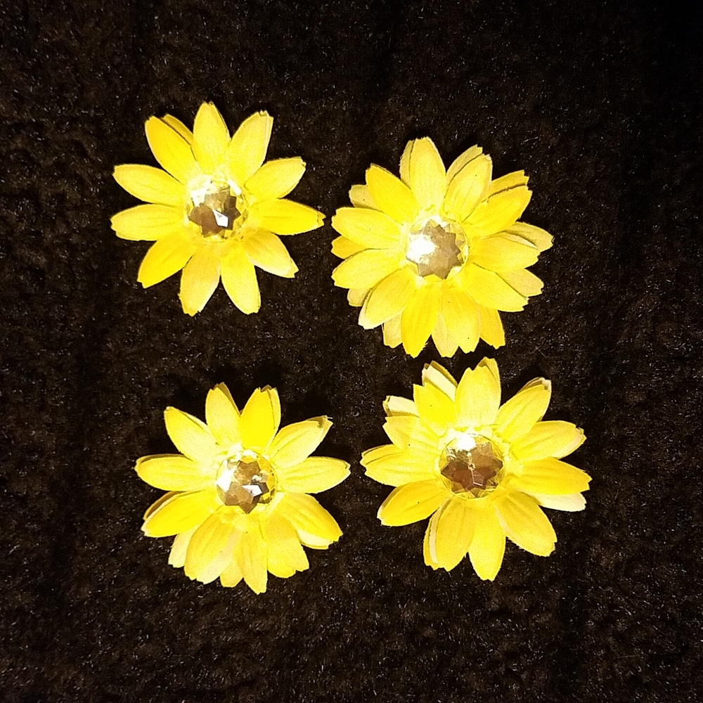 Set of four, sparkly, yellow flowers.  For decorating or crafting.